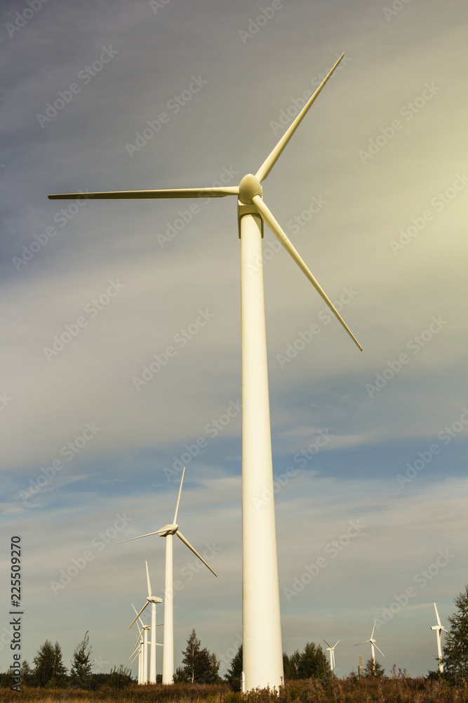 wind generator on blue sky background. electricity production. place for text, at sunset wind generator on blue sky background. electricity production. place for text, at sunset