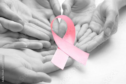 Wallpaper Mural Female hands holding pink ribbon on light background, closeup. Breast cancer awareness concept Torontodigital.ca