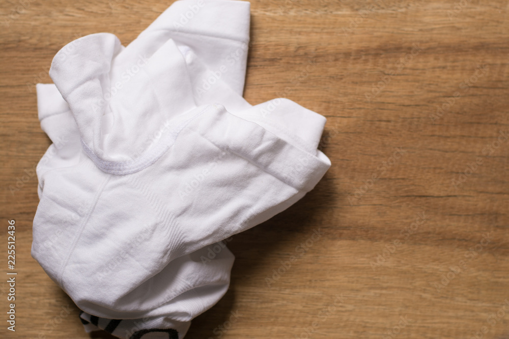 Male underwear keep them neat on the table.New men underwear or short pant and boxer for clothing on wood background. Male underwear keep them neat on the table.New men underwear or short pant and boxer for clothing on wood background.