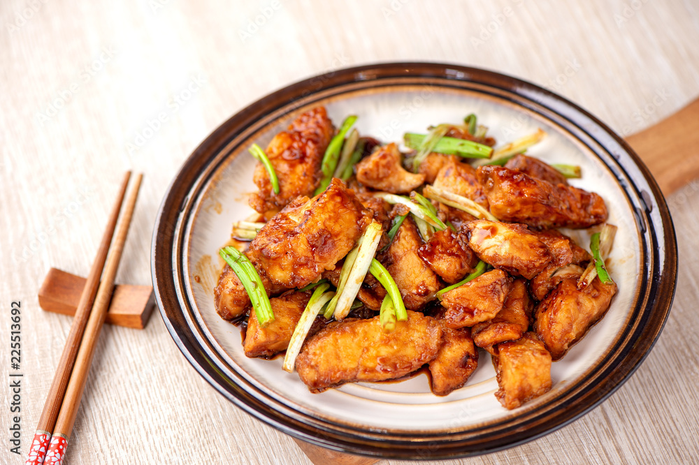 Delicious homemade stewed fish slices with scallion in wooden background, Taiwan delicacies, top view, copy space Delicious homemade stewed fish slices with scallion in wooden background, Taiwan delicacies, top view, copy space