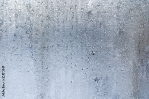 Winter background from lot of frozen water drops on window.