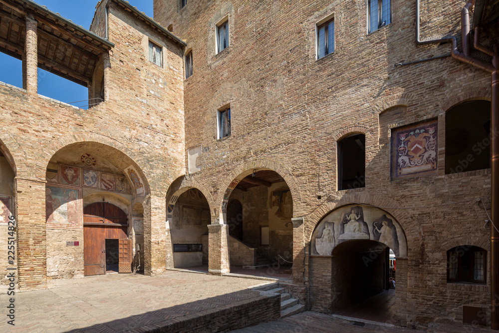 San Gimignano Italy July 2nd 2015 : Entrance and courtyard to the Musei Civici in San Gimignano, Tuscany, Italy San Gimignano Italy July 2nd 2015 : Entrance and courtyard to the Musei Civici in San Gimignano, Tuscany, Italy