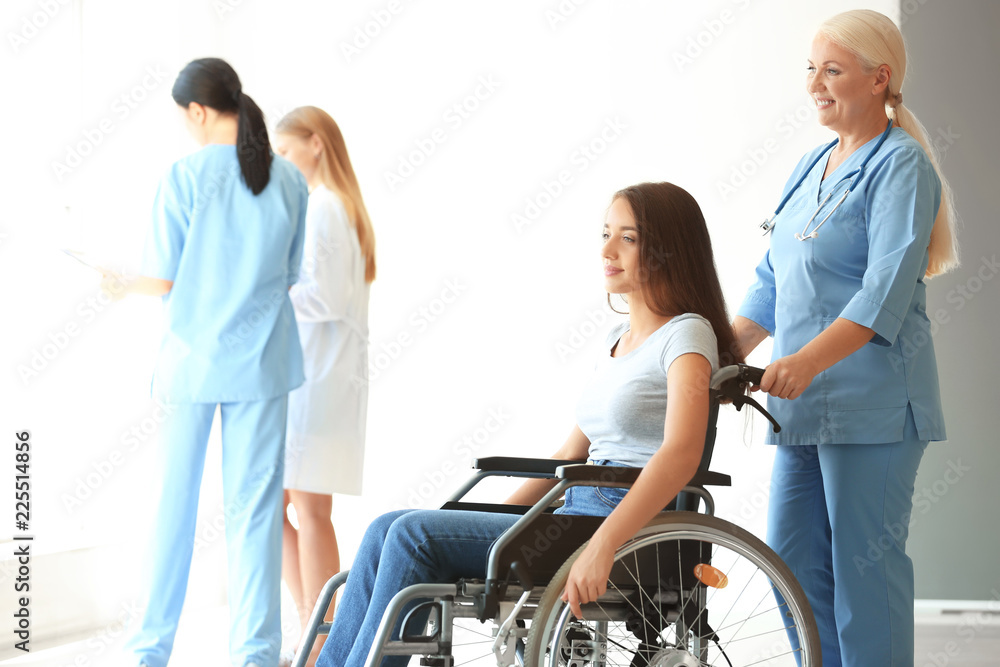Handicapped young woman with mature female doctor in clinic Handicapped young woman with mature female doctor in clinic