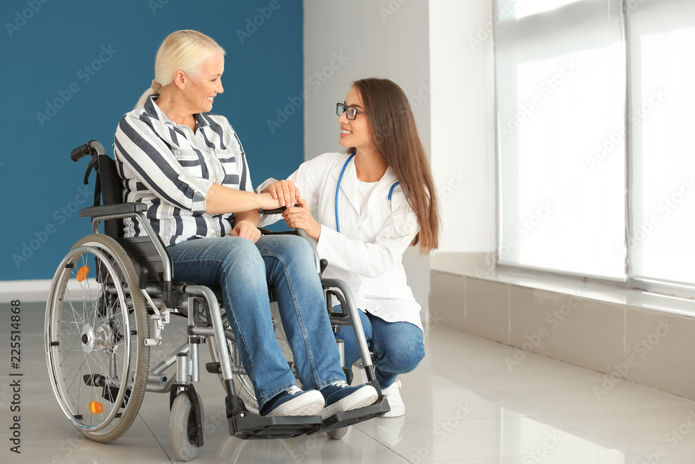 Handicapped mature woman with young female doctor in clinic Handicapped mature woman with young female doctor in clinic