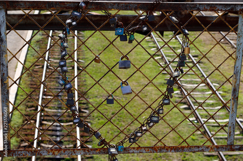 Old padlocks hung in the shape of a heart spread tradition of different peoples of the world .Symbol of eternal love photo