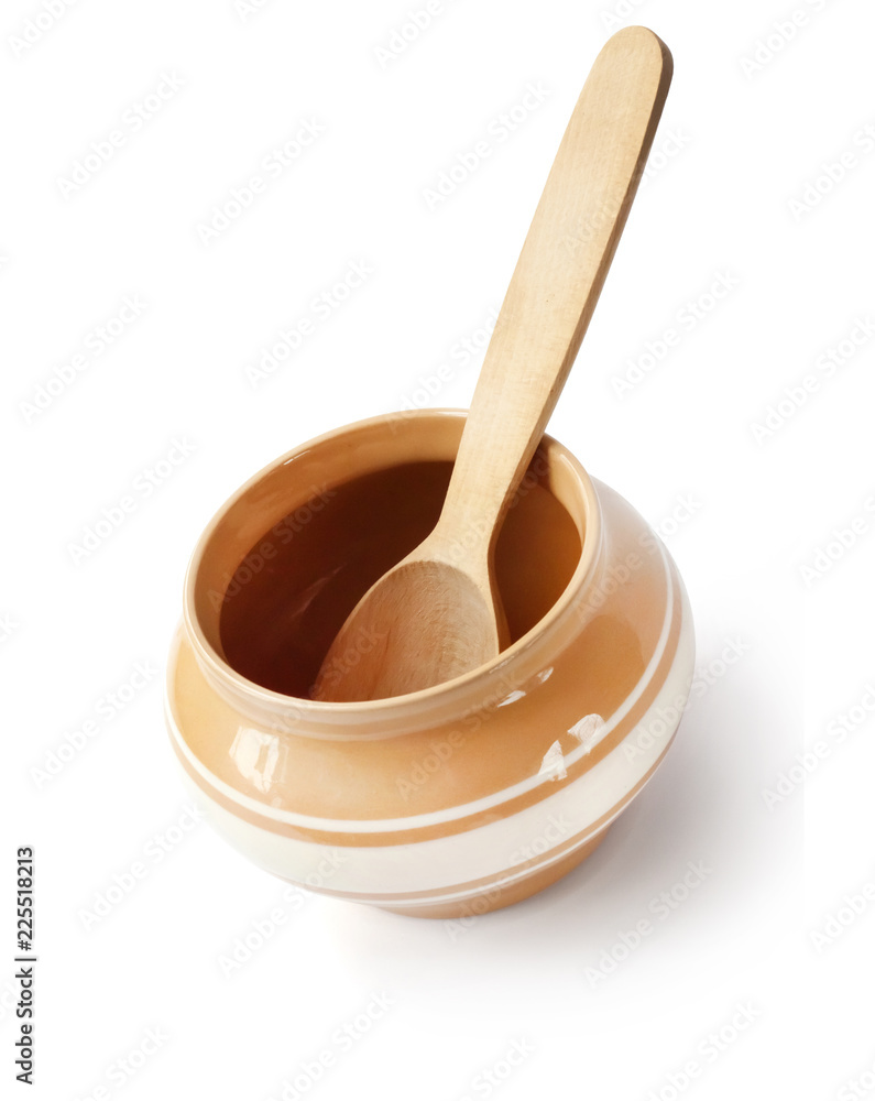 Glazed ceramic pot for cooking with wooden spoon on a white background with clipping path Glazed ceramic pot for cooking with wooden spoon on a white background with clipping path