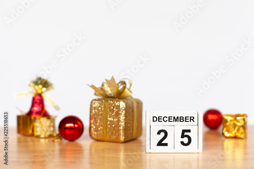 Wooden cubes with the numbers 25 december and christmas decoration object on wood table. Christmas holiday celebration and new year concept