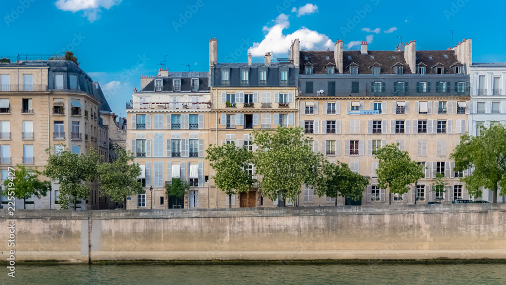 Paris, view of ile saint-louis and quai d'Orleans, typical facades and quays in summer 

