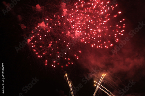 Fireworks. Firework. Heavenly background. Amazing flash of bright red shiny lights in the night sky during the holiday of New Year and Christmas