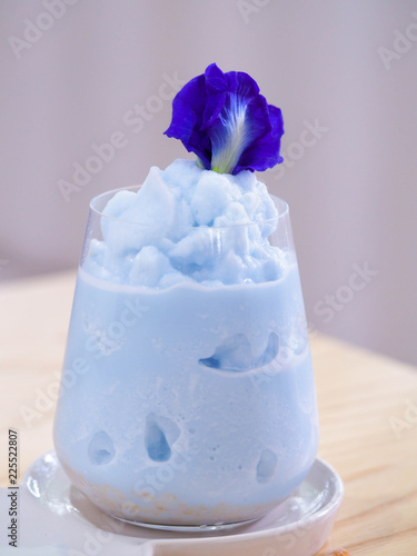 Blue smoothie with pea flower in a cafe. Blue milk shake. Healthy drinking.