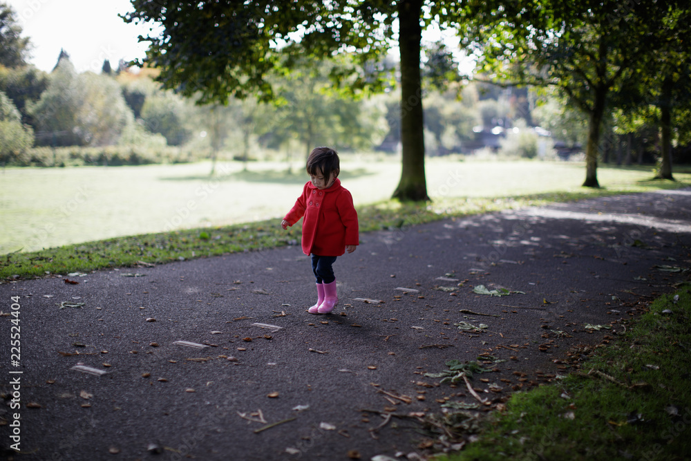 baby girl walk in autumn forest park