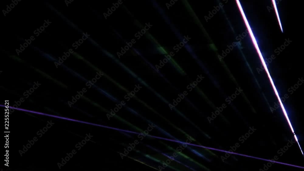 Abstract multicolored rays shine through the smoke on a dark background. Laser show. Abstract multicolored rays shine through the smoke on a dark background. Laser show.