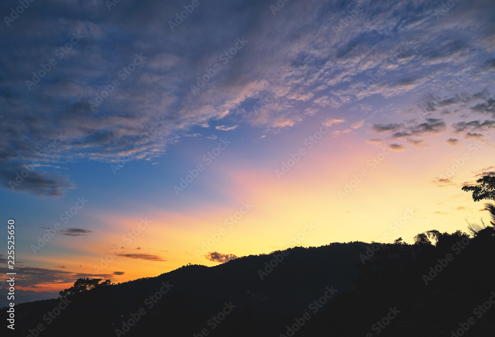 Spectacular sunset over mountains and trees on a tropical island