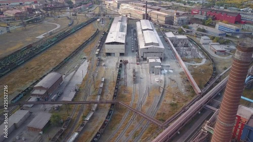 Drone flight over the huge manufacturing site of heavy industry steel plant with transportation system; production of rolling metal,pipes for export; view inside of process; moving train, Magnitogorsk photo