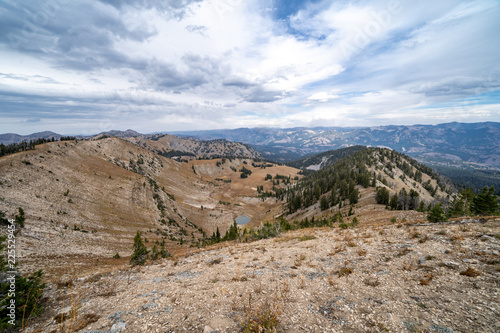 Beautiful view from the summit of mountains in the Bridger Teton National Forest near Jackson Wyoming  featuring a small alpine lake. Autumn season