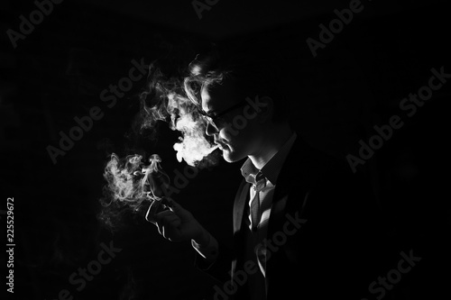 portrait of a man with glasses smoking a cigar