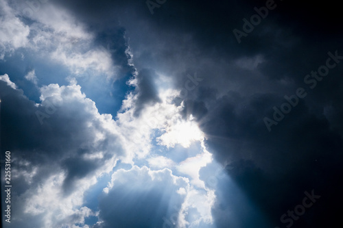 Sun behide clouds and blue sky, silhouette