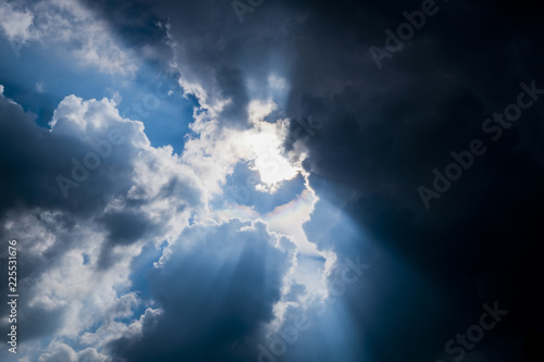 Sun behide clouds and blue sky, silhouette