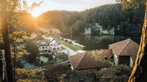 Obraz na plátně Harasov pond with few houses and nice landscape around with road, rocks and hill
