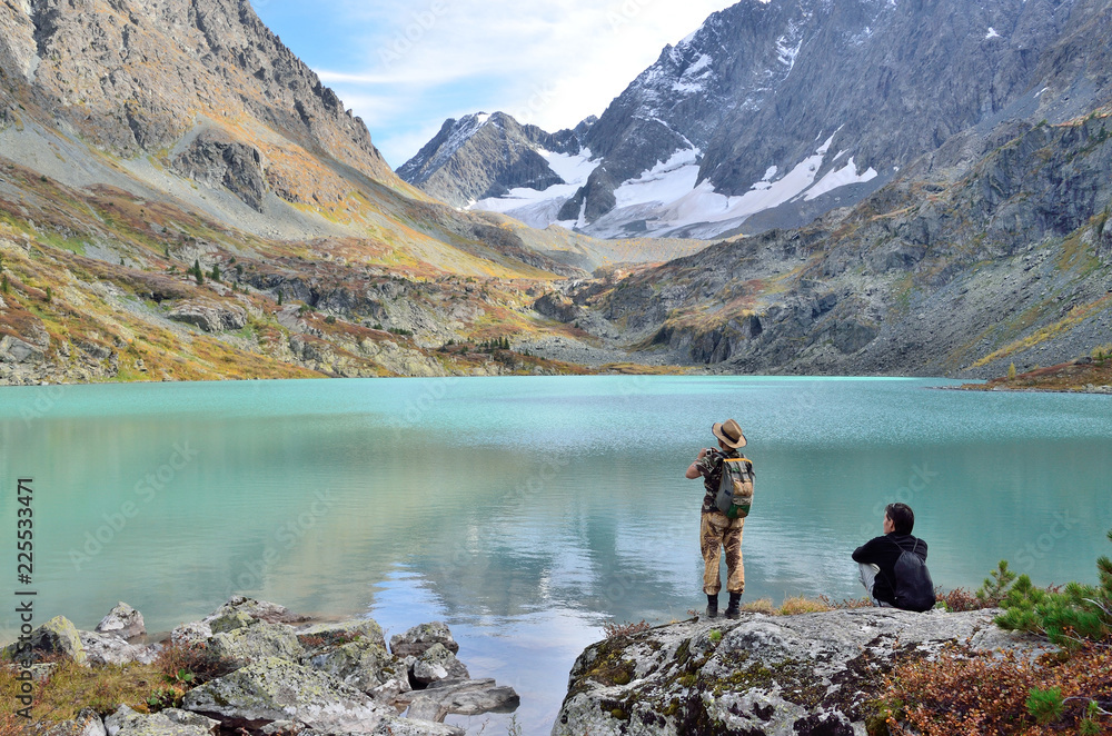Altai territory, Ust-Koksinsky district, Russia. Tourists walking near Kuiguk (Kuyguk) lake Altai territory, Ust-Koksinsky district, Russia. Tourists walking near Kuiguk (Kuyguk) lake