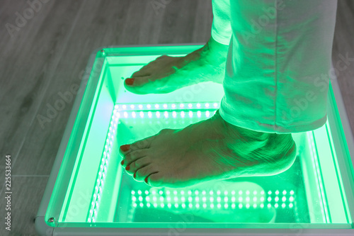 Orthopedics, foot podoscope test. Female feet during a podoscopic examination in an orthopedic surgery