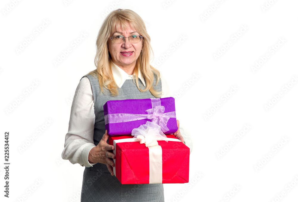 Senior woman with gifts boxes in her hands on a light background. Senior woman with gifts boxes in her hands on a light background.