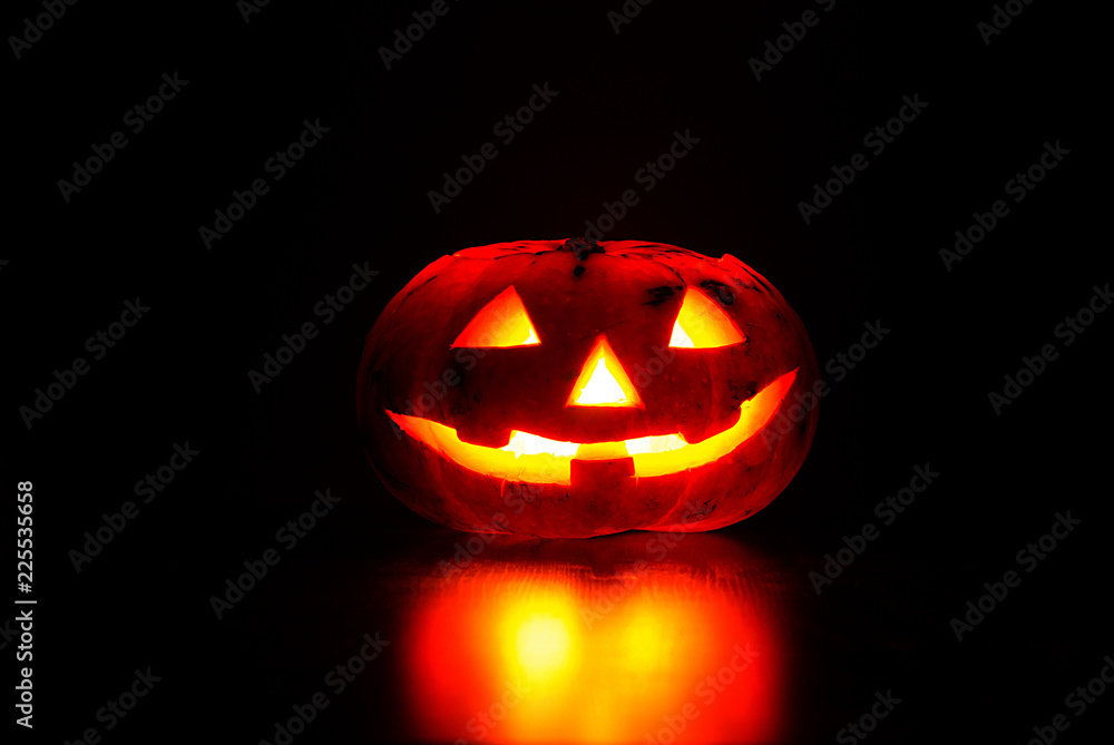 carved from Jack's pumpkin lantern for Halloween party on dark background carved from Jack's pumpkin lantern for Halloween party on dark background