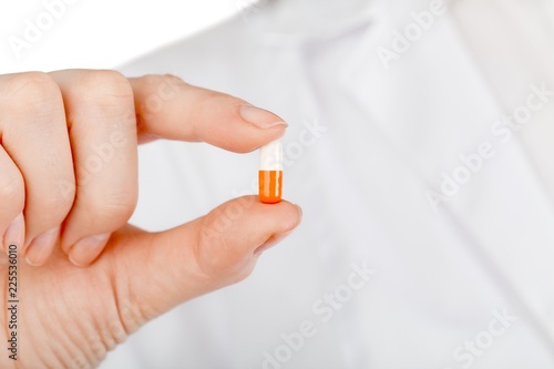 Individual holding a pill