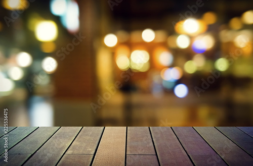 image of wooden table in front of abstract blurred background