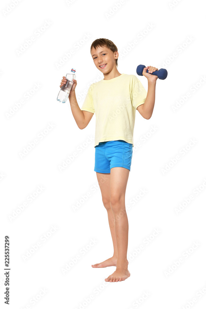 Young boy with dumbbell and bottle of water Young boy with dumbbell and bottle of water