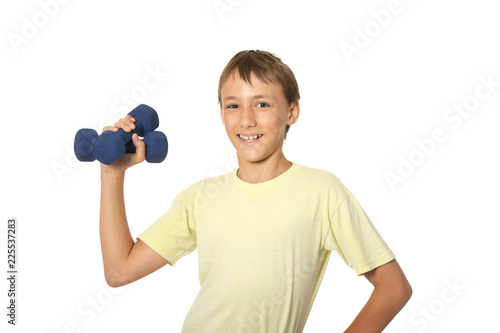 Portrait of young boy doing exercises with dumbbells isolated on white background