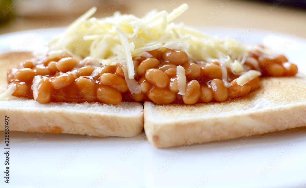 Baked beans on white toast with grated cheese Baked beans on white toast with grated cheese