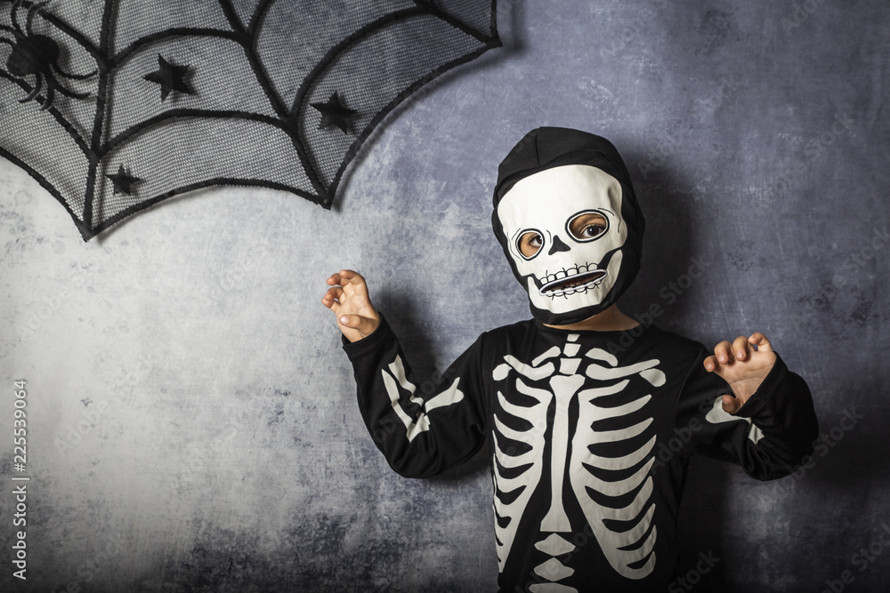 Obraz premium Little kid in a skeleton costume on Halloween Carnival