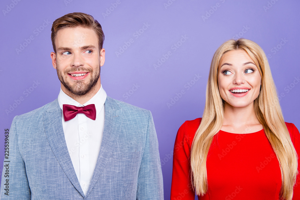 He and she so happy and dreamy! Photo of handsome curious brunet man and blonde lady with straight hair look to each other in classy wear with bowtie isolated on bright purple violet background He and she so happy and dreamy! Photo of handsome curious brunet man and blonde lady with straight hair look to each other in classy wear with bowtie isolated on bright purple violet background