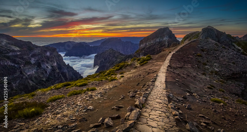 Madeira, Portugal. Hiking path between Pico do Arieiro and Pico do Ruivo at sunset above the clouds