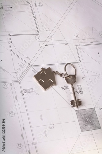 House Key With Keychain On Construction Plan Close-up