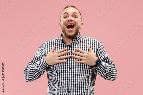 I won. Winning success happy man celebrating being a winner. Dynamic image of caucasian male model on pink studio background. Victory, delight concept. Human facial emotions concept. Trendy colors