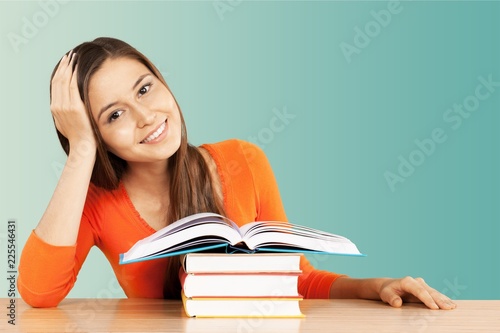 Young female student reading books