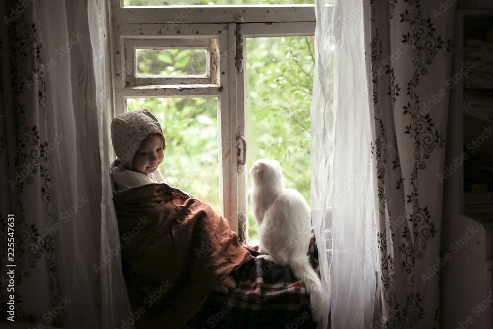 Toddler girl with cat sitting on window,childhood Toddler girl with cat sitting on window,childhood