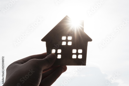 House model in home insurance broker agent ‘s hand or in salesman person with sky background. Real estate agent offer house, property insurance and security, affordable housing concepts