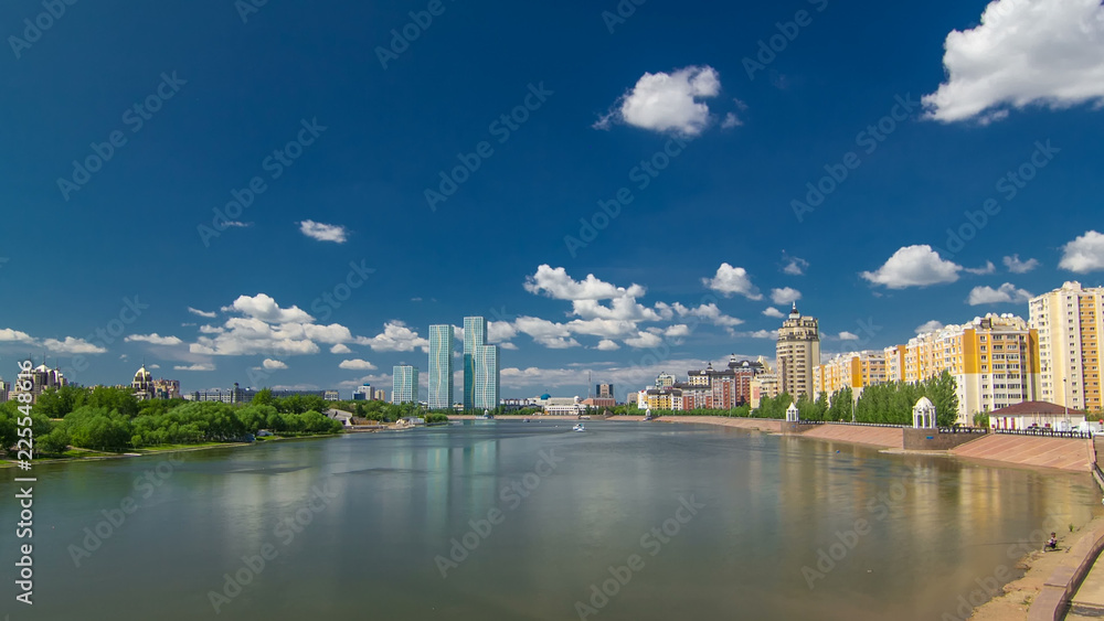 Yesil river timelapse hyperlapse with modern towers of residential complex in Astana