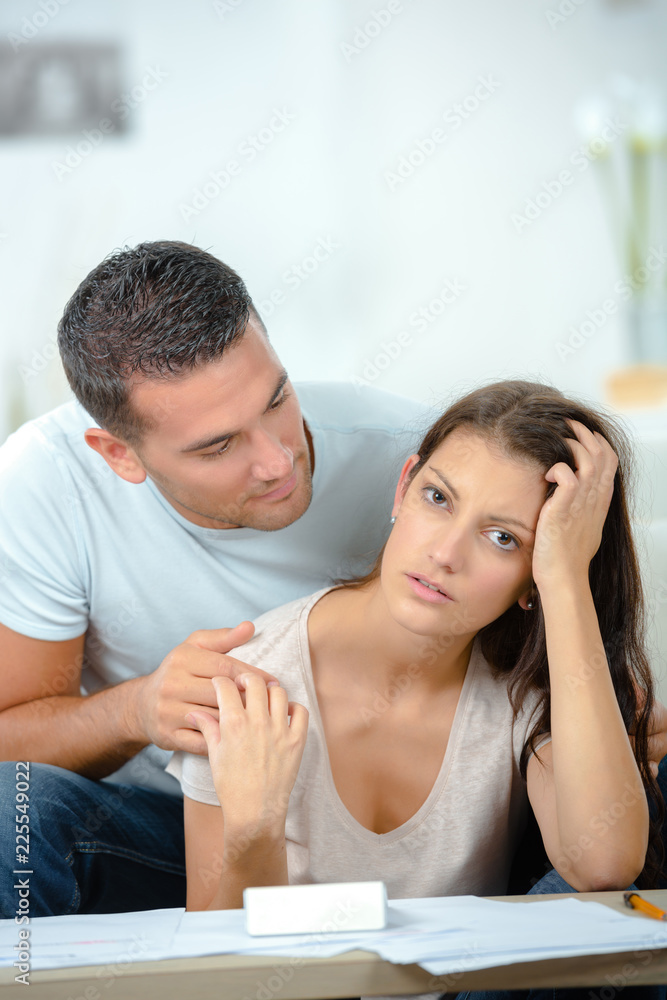 worried couple after fight sitting on sofa worried couple after fight sitting on sofa