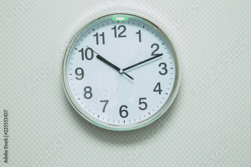 Time Punctual Second Minute Hour Concept . Wall white clock and shelf at abstract white background . close up of an office clock on white background with clipping path