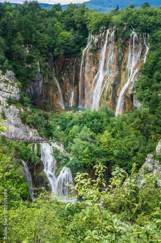 Plitvice National Park  Croatia. Wood plank path through green forest and over the water