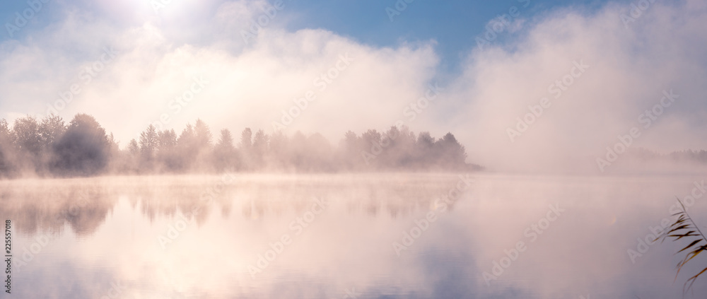 Beautiful foggy morning. Fog over autumn lake at sunrise moment. Wide panorama. Beautiful foggy morning. Fog over autumn lake at sunrise moment. Wide panorama.