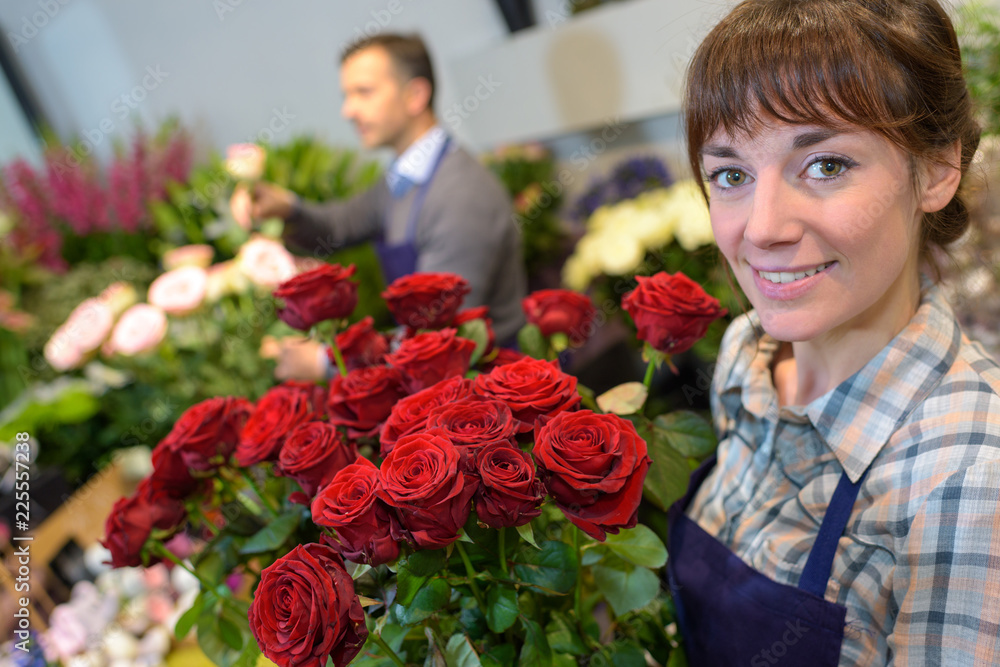 Florist holding bouquet of roses