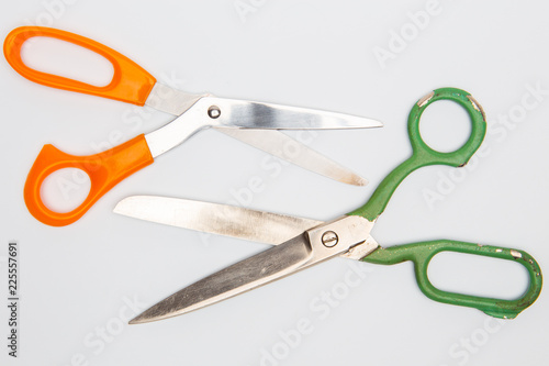 Scissors for different purposes and sizes on a white background, vintage and new, plastic and metal, top view photo