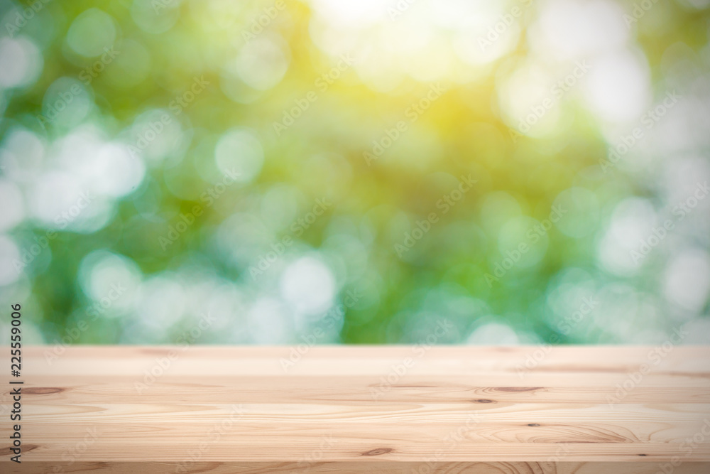 Blur green with wooden table space for products display montage background Blur green with wooden table space for products display montage background