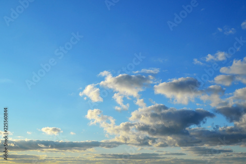 Light white clouds high in a blue sky on a sunny day background