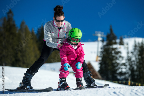 Wallpaper Mural Mother and little child skiing in Alps mountains. Active mom and toddler kid with safety helmet, goggles and poles. Ski lesson for young children. Winter sport for family. Little skier, swiss Alps Torontodigital.ca